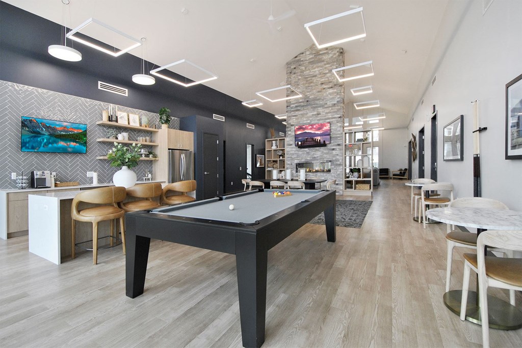 a billiards table in a clubhouse at the district at highland village apartments
