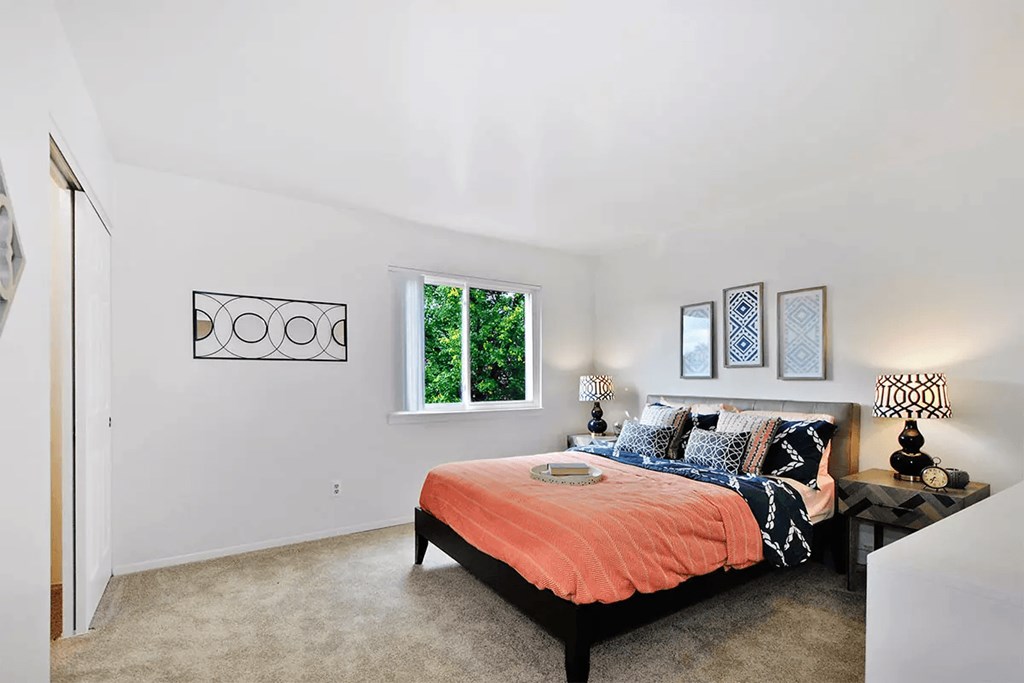 a bedroom with a bed and a window