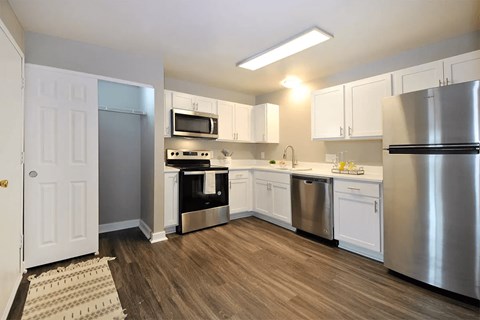 a kitchen with stainless steel appliances and white cabinets