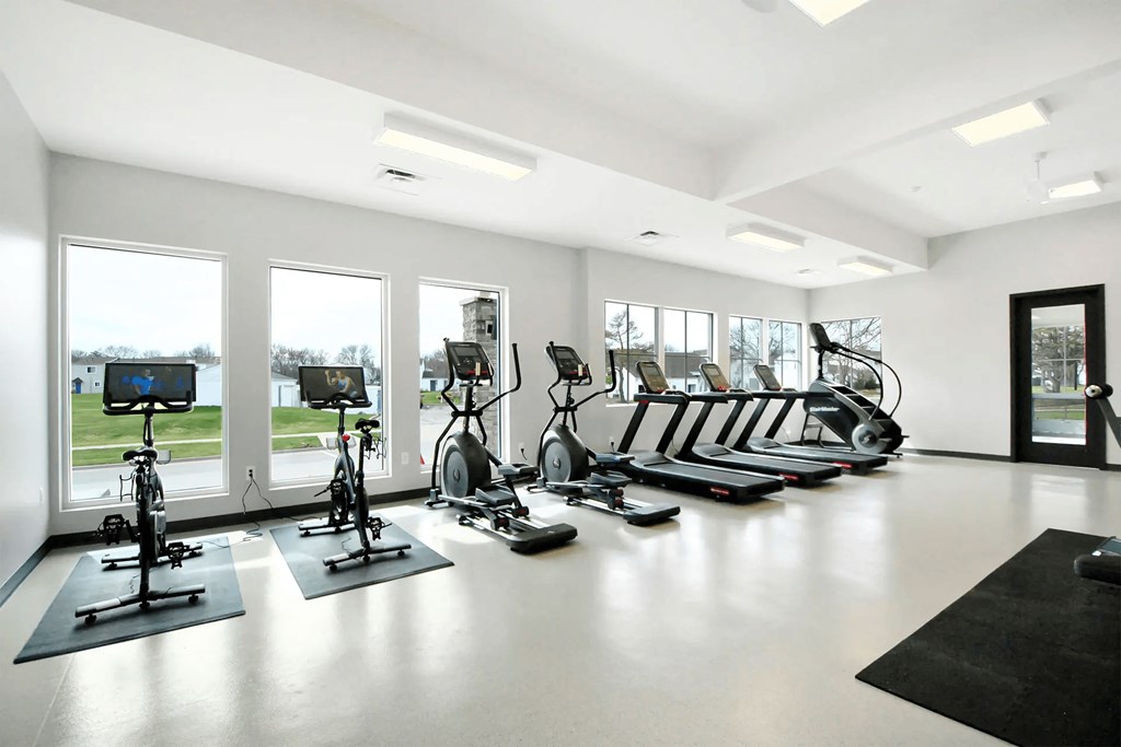 fitness center with elliptical machines and treadmills