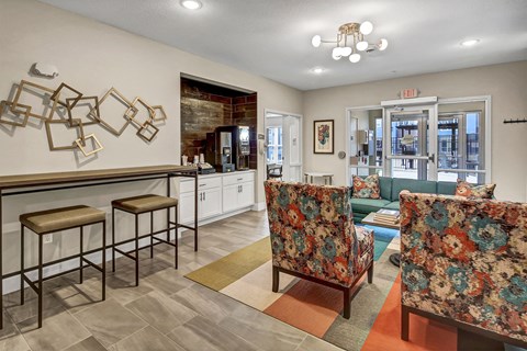 a living room with furniture and a bar with stools