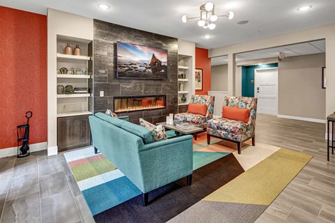 a living room with couches and chairs and a fireplace