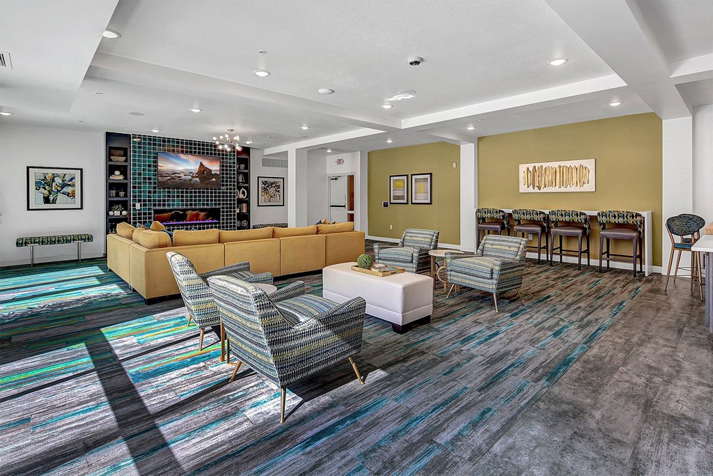 a living room with couches and chairs and a table with chairs