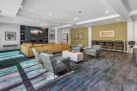 a living room with couches and chairs and a table with chairs