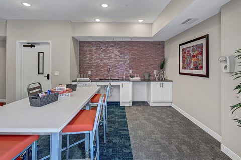 a dining room with a long table and chairs and a brick wall