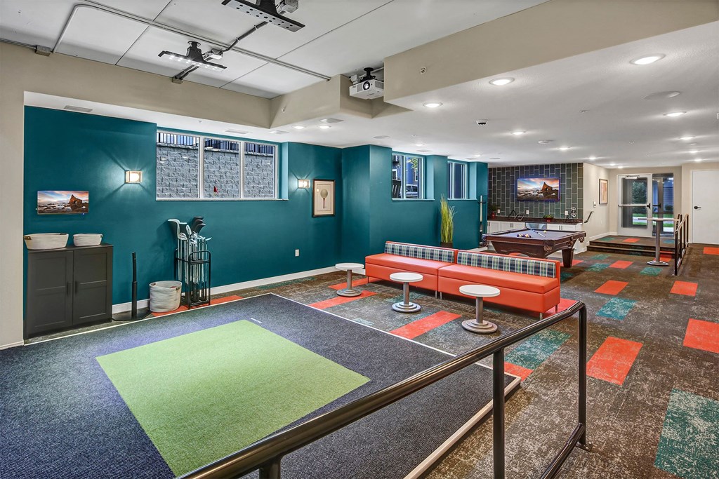 a game room with a ping pong table and a couch