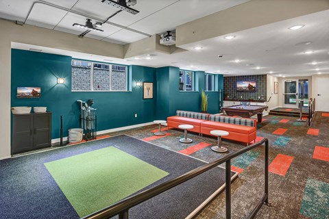 a game room with a ping pong table and a couch