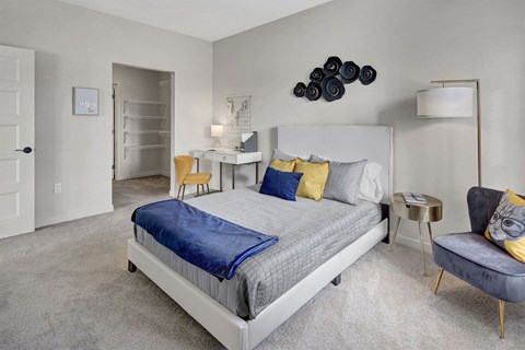 a bedroom with a bed and a desk and a chair