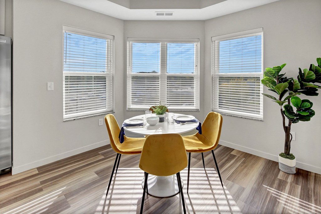 an image of a dining room with a table and chairs