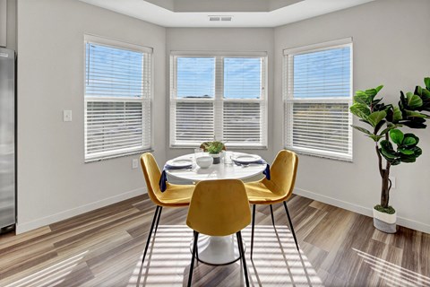 an image of a dining room with a table and chairs