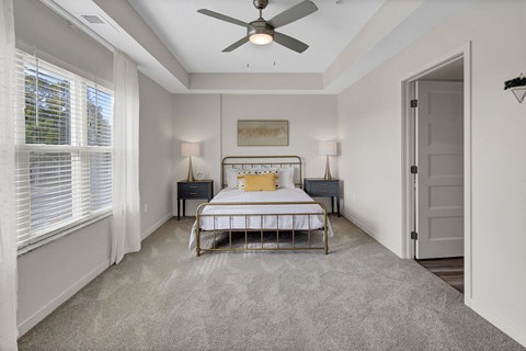 a bedroom with a bed and a ceiling fan
