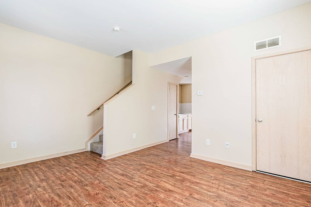 A room with a staircase and a door.