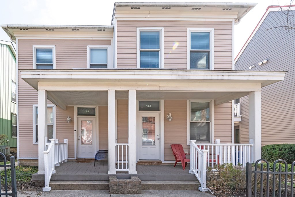 A house with a porch and a red chair.