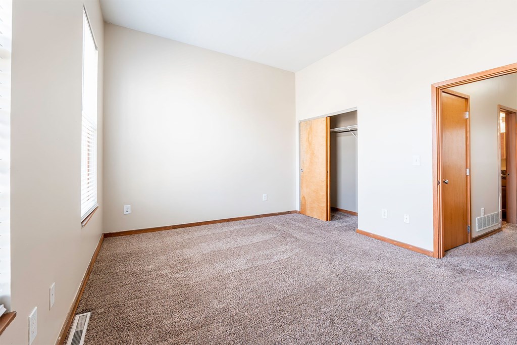 A room with a carpeted floor and white walls.