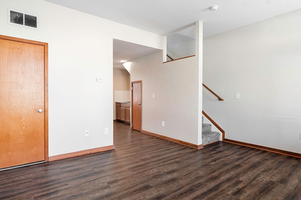A room with a wooden floor and a wooden door.