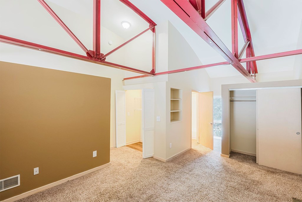 A room with a brown wall and a carpeted floor.