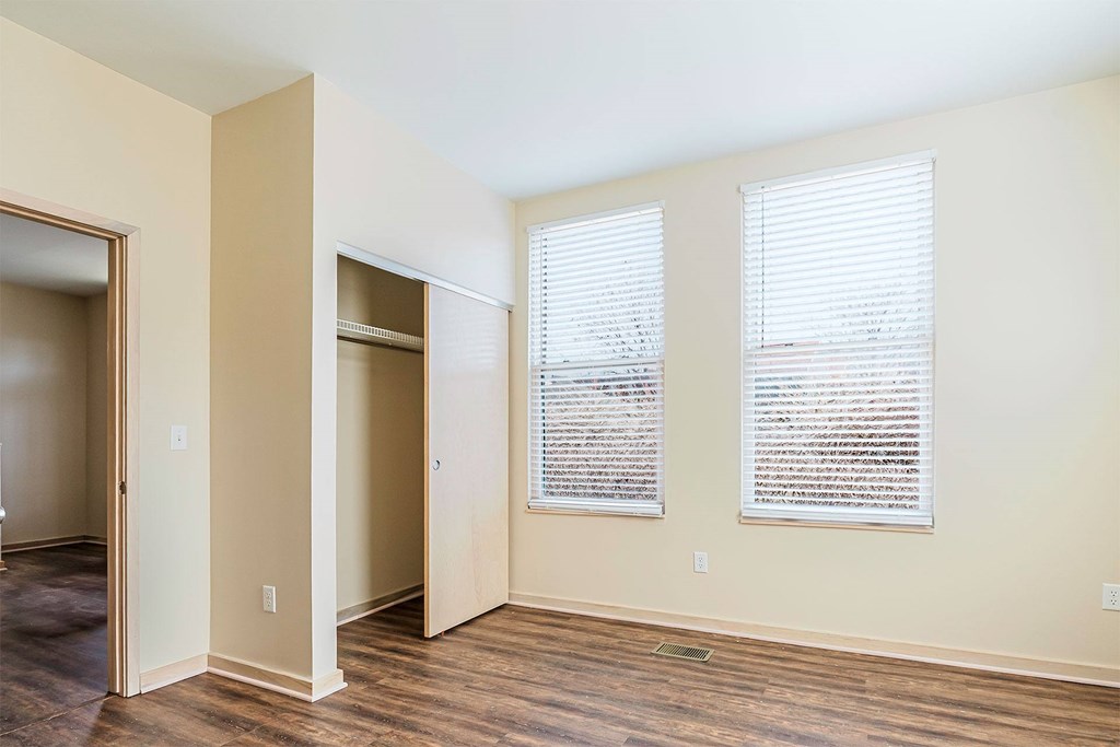 A room with two windows and a door.