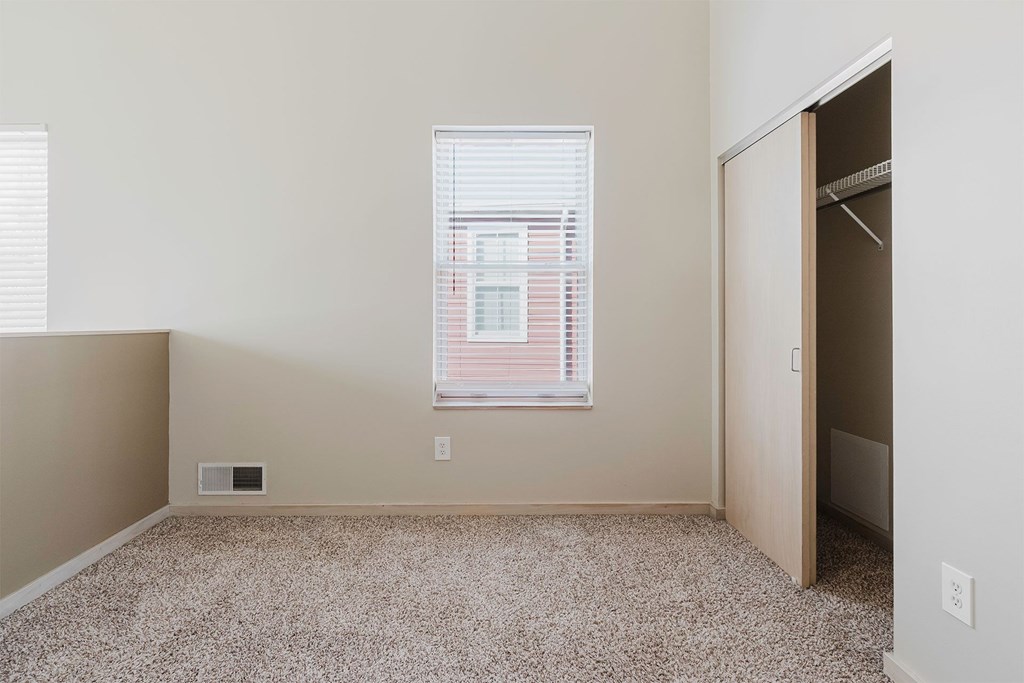 A room with a window and a door.