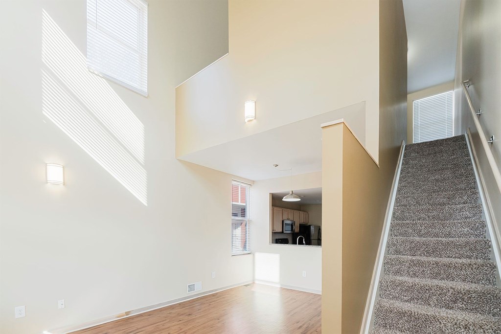 A staircase leads up to a kitchen area in a modern home.