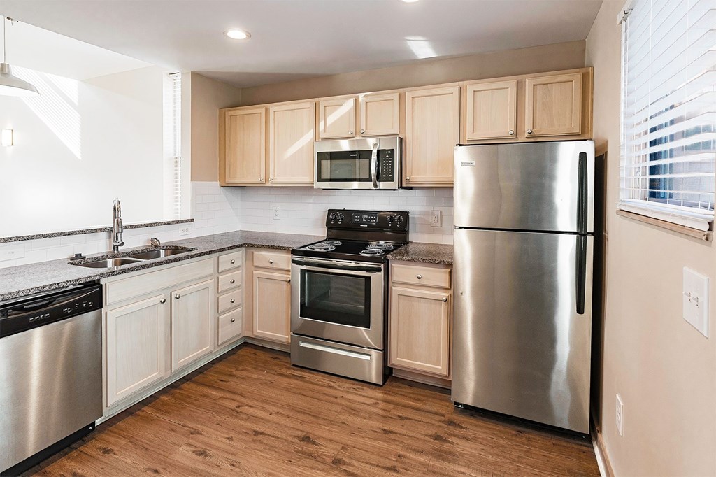 A kitchen with wooden cabinets and stainless steel appliances.