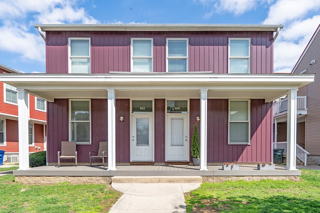 A red house with a white door and windows.