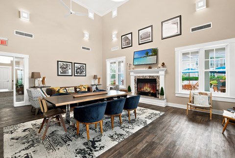 A dining room with a fireplace and a view of the outside.