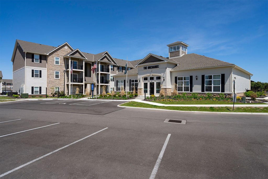 A large building with a parking lot in front of it.