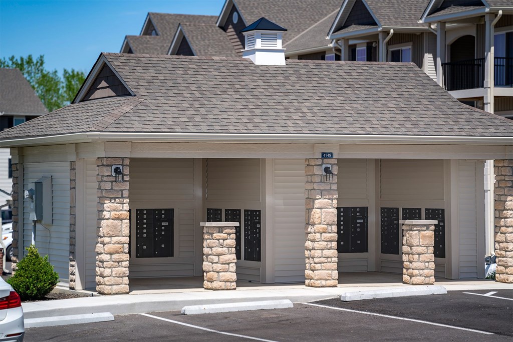 A building with a stone pillar entrance and a grey roof.