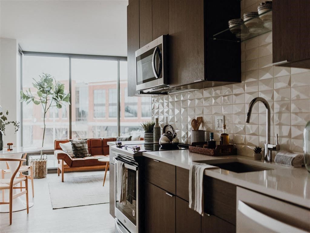 a kitchen with a stove top oven next to a window