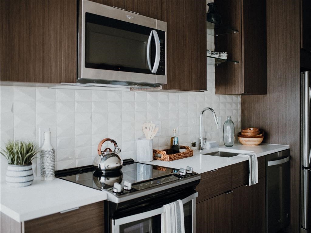 a kitchen with a stove top oven next to a sink