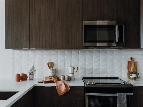 a kitchen with a stove top oven next to a microwave