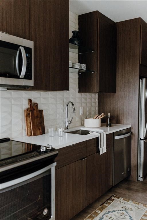 a kitchen with a stove a sink and a microwave