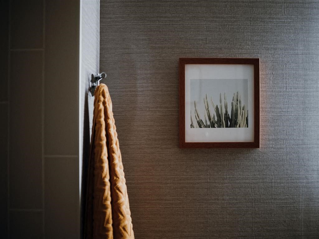 a picture hanging on a wall next to a towel
