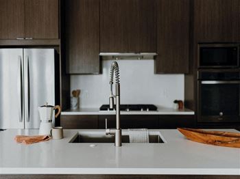 a kitchen with a sink and a refrigerator