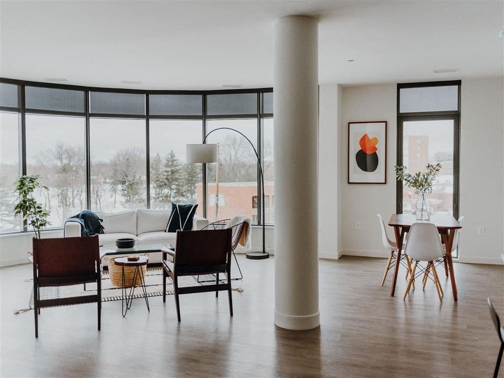 a living room and dining room with large windows