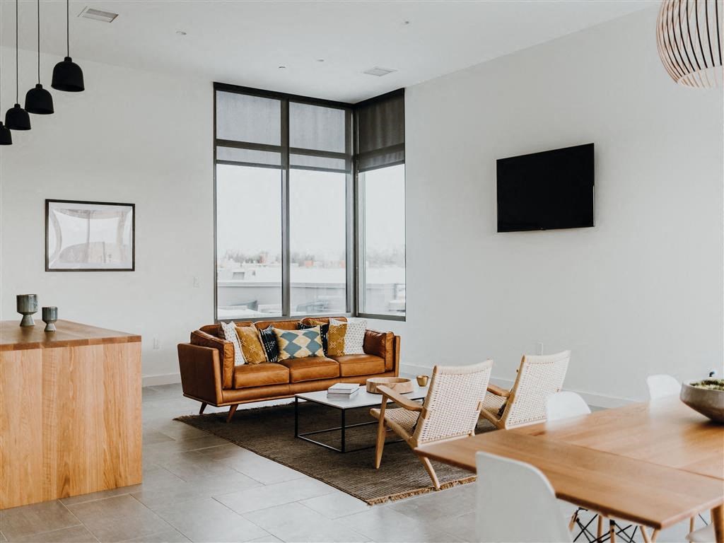 a living room filled with furniture and a flat screen tv