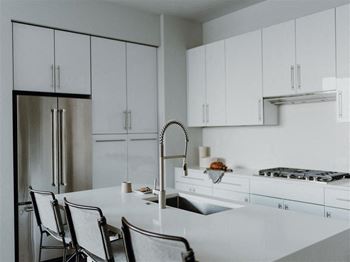 a kitchen with white cabinets and a white counter top