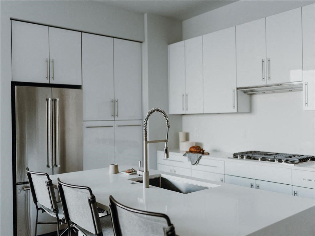 a kitchen with white cabinets and a white counter top