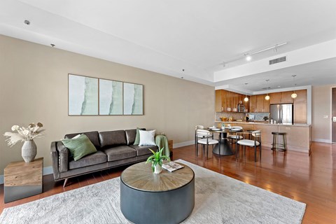 A modern living room with a grey sofa and a wooden coffee table.