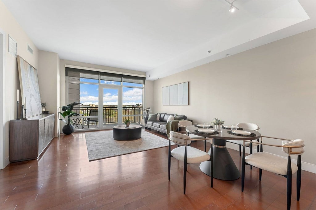 A modern dining room with a table set for six.