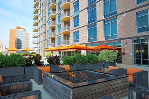 A modern building with a patio area in front.