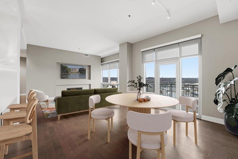 A modern dining room with a round table and chairs.