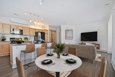 A modern dining room with a white table set for four.