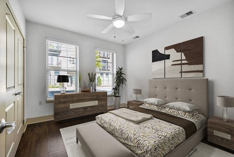 A bedroom with a large bed and a ceiling fan.
