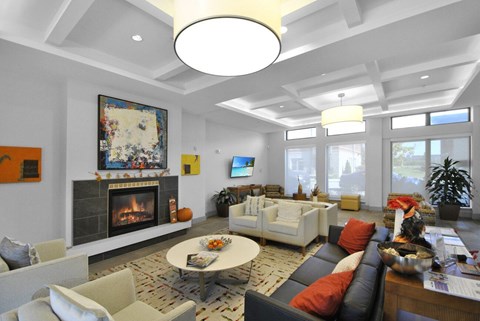 A living room with a fireplace and a painting on the wall.