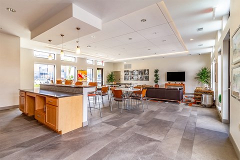 A modern kitchen with a dining table and chairs.