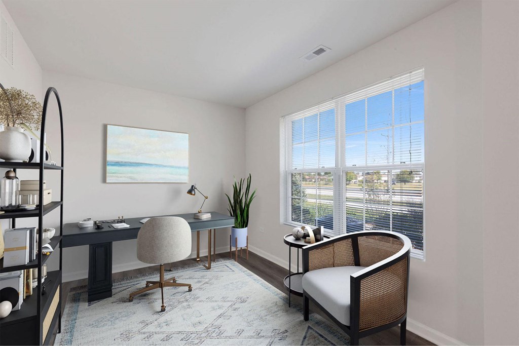 A room with a desk, chair, and a painting on the wall.