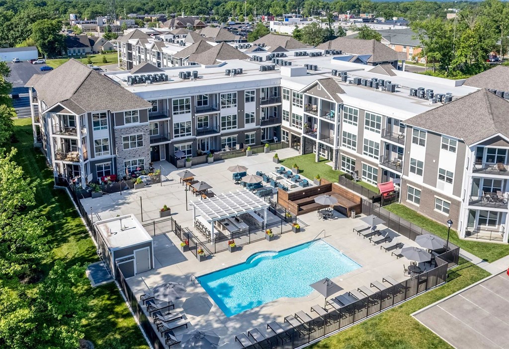 an aerial view of an apartment building with a swimming pool