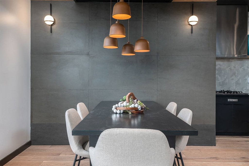 a dining room with a black table and white chairs