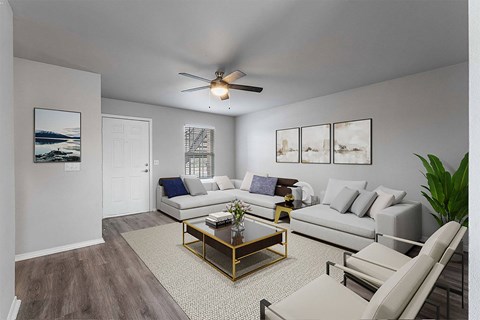 A living room with a white couch, a coffee table, and a ceiling fan.